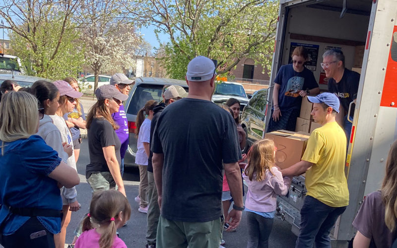 Volunteers unloading food boxes from truck