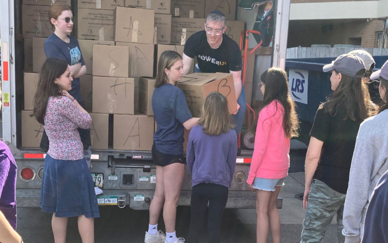 Volunteers unloading food boxes from truck