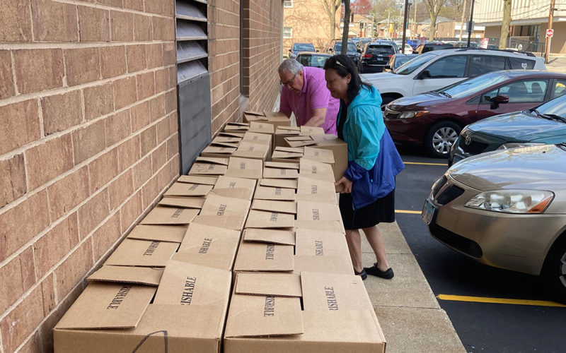 Volunteers loading food boxes into cars